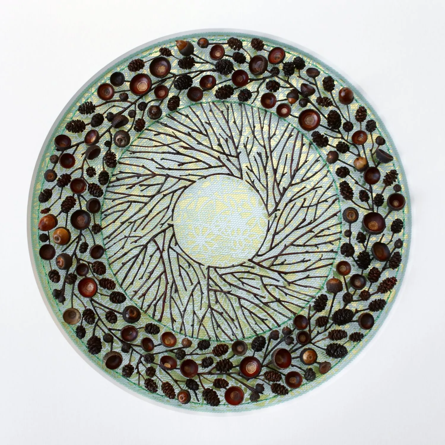 A circle created with plain twigs and twigs with berries on them.