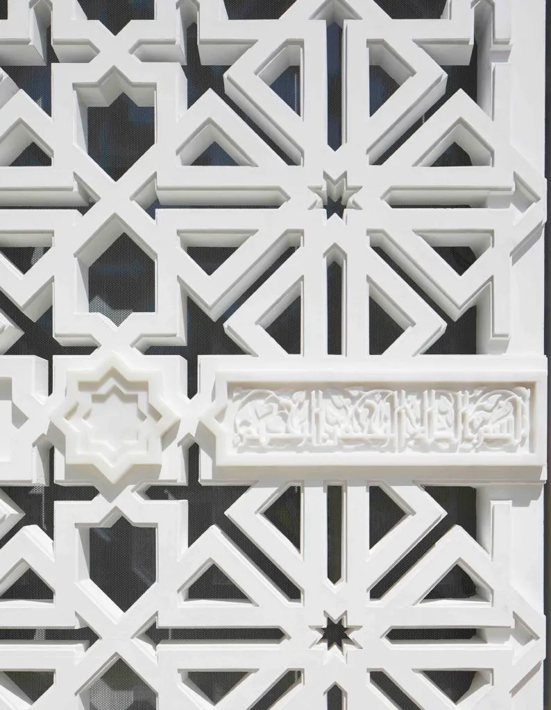 A close-up on the pattern on the stone and calligraphy on the marble